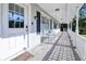 Inviting front porch with wooden flooring and seating area at 3173 S Cranberry Blvd, North Port, FL 34286