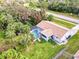 Aerial view of a house with a pool and palm trees in the yard at 3173 S Cranberry Blvd, North Port, FL 34286