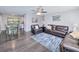Spacious living room with dark hardwood floors and leather furniture at 3173 S Cranberry Blvd, North Port, FL 34286