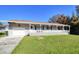 Single story home with a large front porch and attached garage at 3173 S Cranberry Blvd, North Port, FL 34286