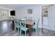 Charming dining area with a rustic wooden table and teal chairs at 3173 S Cranberry Blvd, North Port, FL 34286