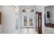 Elegant entryway with double doors and a grand chandelier at 13878 Allamanda Cir, Port Charlotte, FL 33981