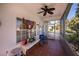 Relaxing screened porch with tiled floor, ceiling fan, and comfortable seating at 1307 Red Oak Ln, Port Charlotte, FL 33948