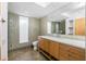 Modern bathroom with wood vanity, terrazzo countertop, and mosaic tile at 1 Colony Point Dr # 16B, Punta Gorda, FL 33950