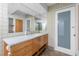 Bathroom with wood vanity, terrazzo countertop, and tiled walls at 1 Colony Point Dr # 16B, Punta Gorda, FL 33950