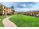 Community featuring a large grassy area, building, and parking at 1 Colony Point Dr # 16B, Punta Gorda, FL 33950