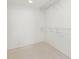 Spacious walk-in closet with wire shelving and hanging rods at 1 Colony Point Dr # 16B, Punta Gorda, FL 33950