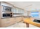 Modern kitchen with stainless steel appliances and island at 1 Colony Point Dr # 16B, Punta Gorda, FL 33950