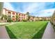 Community with lush green lawn, building and parking area at 1 Colony Point Dr # 16B, Punta Gorda, FL 33950