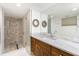 Modern bathroom with a walk-in shower and wood vanity at 1 Colony Point Dr # 16B, Punta Gorda, FL 33950