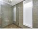 Large walk-in shower with glass enclosure and mosaic tile at 1 Colony Point Dr # 16B, Punta Gorda, FL 33950