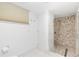 Bathroom with a walk-in shower with stone tile and a modern door at 1 Colony Point Dr # 16B, Punta Gorda, FL 33950