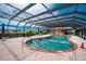 Heated kidney-shaped pool with covered patio and lounge chairs at 1 Colony Point Dr # 16B, Punta Gorda, FL 33950