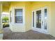 Front door entrance with tiled flooring and windows at 25353 Puerta Dr, Punta Gorda, FL 33955