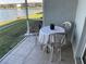 Small patio with table and chairs, overlooking a lake at 3310 Loveland Blvd # 604, Port Charlotte, FL 33980