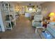Living room with tiled floor, comfy seating, and partial kitchen view at 3310 Loveland Blvd # 604, Port Charlotte, FL 33980