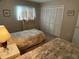 Guest bedroom with two twin beds and dresser at 3310 Loveland Blvd # 604, Port Charlotte, FL 33980