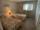 Guest bedroom with two twin beds and dresser at 3310 Loveland Blvd # 604, Port Charlotte, FL 33980