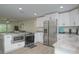 Modern kitchen with white cabinets, granite countertops, and stainless steel appliances at 25 Caddy Rd, Rotonda West, FL 33947