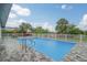 Inviting pool area with patio furniture and lush landscaping at 25 Caddy Rd, Rotonda West, FL 33947