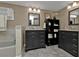 Double vanity bathroom with marble-look tile and gray cabinets at 2328 Bonn Ct, Punta Gorda, FL 33983