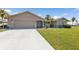 Single story home with attached garage and landscaped lawn at 2328 Bonn Ct, Punta Gorda, FL 33983