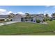 Single-story home with a 2 car garage and green lawn at 2328 Bonn Ct, Punta Gorda, FL 33983