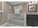 Updated bathroom with gray vanity, marble tile, and a soaking tub at 2328 Bonn Ct, Punta Gorda, FL 33983