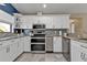 Modern kitchen with white cabinets, granite counters, and stainless steel appliances at 2328 Bonn Ct, Punta Gorda, FL 33983