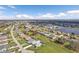 Aerial view showcasing a desirable neighborhood with homes surrounding a tranquil lake at 2328 Bonn Ct, Punta Gorda, FL 33983