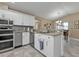 Modern kitchen with white cabinets, granite counters, and stainless steel appliances at 2328 Bonn Ct, Punta Gorda, FL 33983