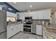 Modern kitchen with white cabinets, granite counters, and stainless steel appliances at 2328 Bonn Ct, Punta Gorda, FL 33983