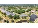 An elevated shot captures the beauty of a golf course community, with lush landscaping and a peaceful water feature at 1355 Saxony Cir # 211, Punta Gorda, FL 33983