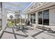 View of the lanai with a patio set and stairs leading up to the house at 171 Morgan Se Ln, Port Charlotte, FL 33952