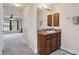 Bathroom with wood vanity, granite countertop, and mirror at 1753 Naftal Rd, North Port, FL 34288