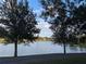 Lake view with trees, a paved path, and a dock at 2615 E Curtis St, Tampa, FL 33610