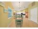 Charming dining area with wood table and four teal chairs at 4040 S Cranberry Blvd, North Port, FL 34286