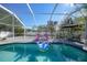 Inviting screened pool area with lounge chairs and a fun pool floatie at 4040 S Cranberry Blvd, North Port, FL 34286