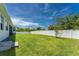 Large backyard with lush lawn and white vinyl fence at 9973 Calumet Blvd, Port Charlotte, FL 33981
