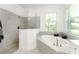 Spa-like bathroom with a soaking tub, walk-in shower, and updated fixtures at 9973 Calumet Blvd, Port Charlotte, FL 33981