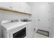 Bright laundry room with washer, dryer, and upper cabinets at 9973 Calumet Blvd, Port Charlotte, FL 33981