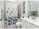 Clean bathroom with shower/tub combo, vanity, and patterned shower curtain at 9973 Calumet Blvd, Port Charlotte, FL 33981