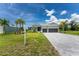 Two-car garage, gray exterior, and a paved driveway at 9973 Calumet Blvd, Port Charlotte, FL 33981
