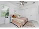 Bright bedroom featuring a comfortable bed, ceiling fan, and ample closet space at 9973 Calumet Blvd, Port Charlotte, FL 33981