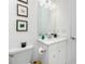 Modern bathroom with white vanity, toilet, and a framed mirror at 9973 Calumet Blvd, Port Charlotte, FL 33981