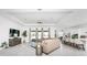 Spacious living room features a sectional sofa, large windows, and ceiling fan at 9973 Calumet Blvd, Port Charlotte, FL 33981
