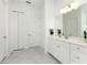 Bright bathroom boasts a vanity with quartz countertop, and grey tile flooring at 9973 Calumet Blvd, Port Charlotte, FL 33981