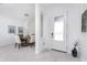 Bright dining room with a round table and four chairs, features modern lighting and art at 9973 Calumet Blvd, Port Charlotte, FL 33981