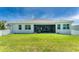 Home exterior showcasing a large backyard and patio at 9973 Calumet Blvd, Port Charlotte, FL 33981