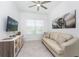Bright den featuring a comfortable sofa and large wall-mounted TV at 9973 Calumet Blvd, Port Charlotte, FL 33981